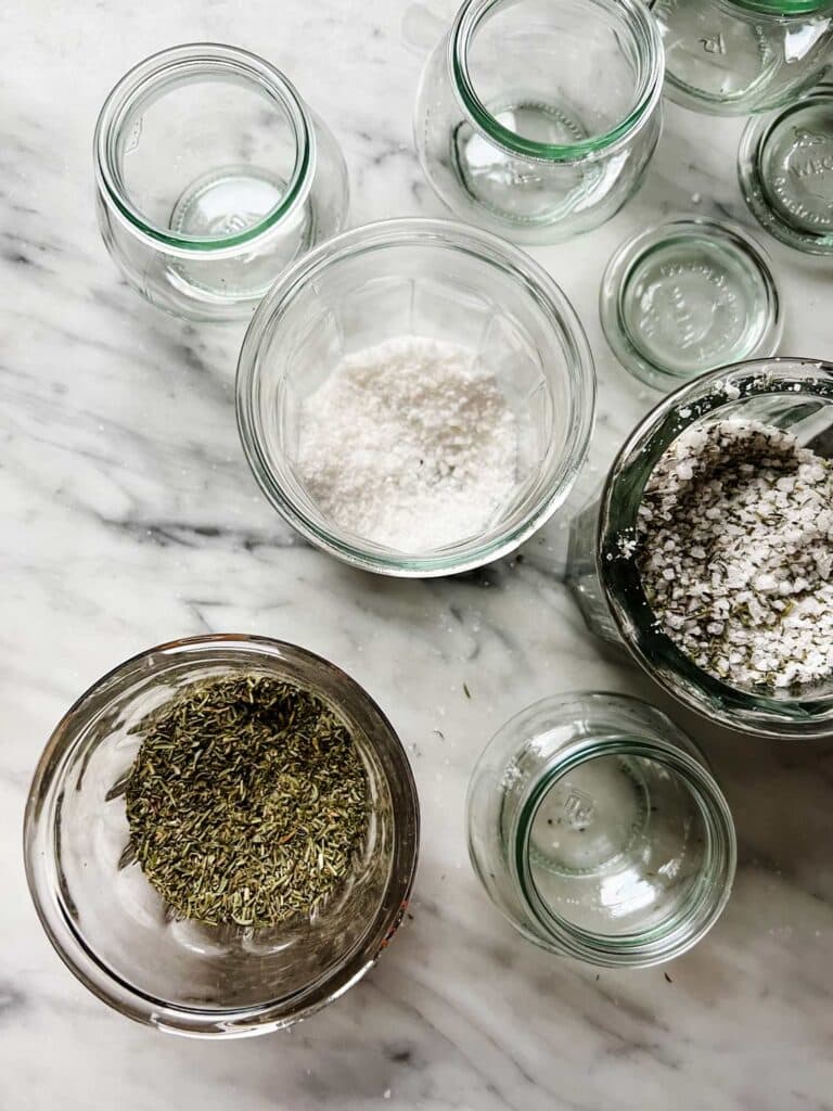 French herbs and salts are mixed to placed in small jars to give as gifts.