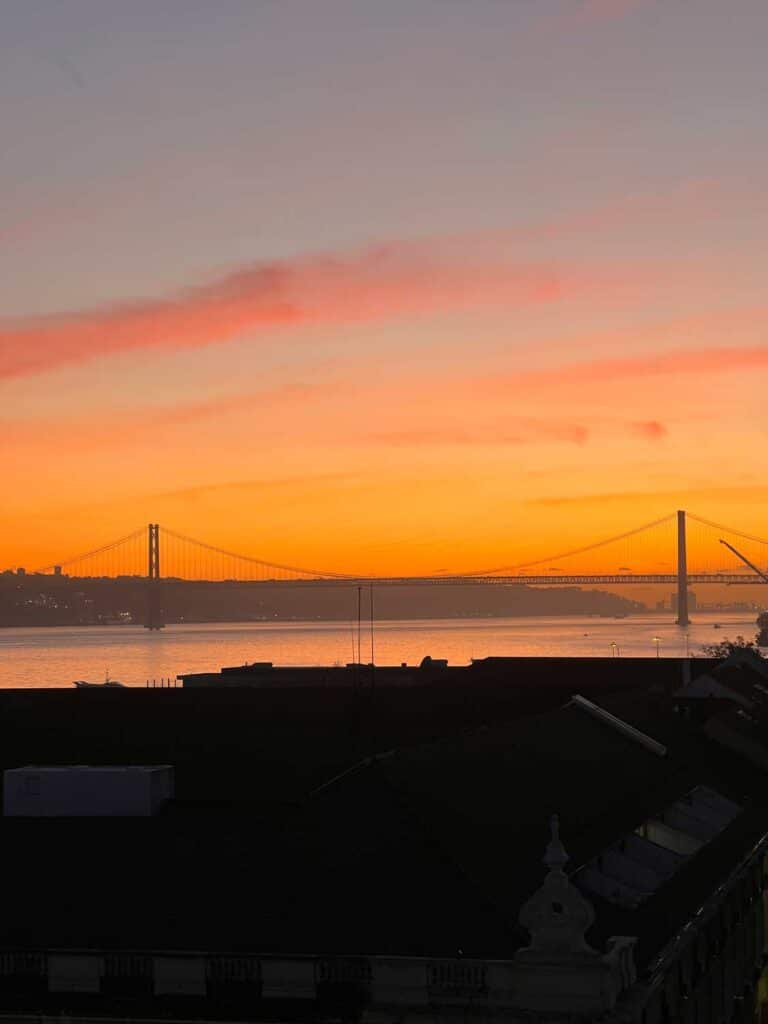 A sunset view of the bridge and Tagus river from the tower at Pracá do Commercio.