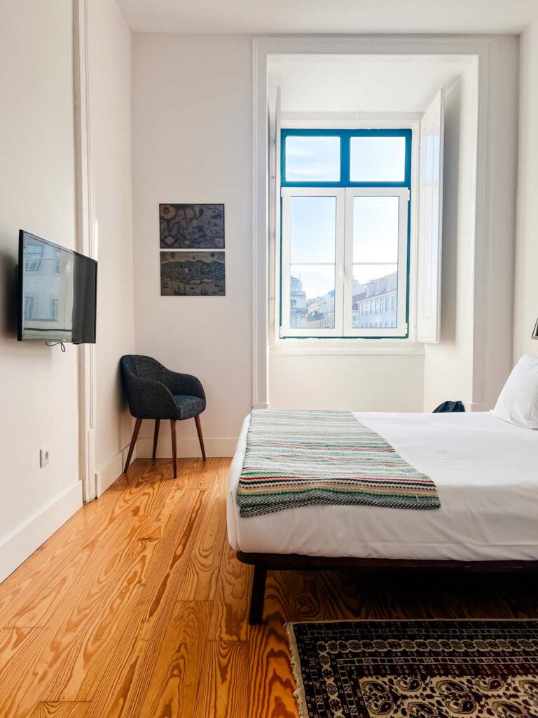 A guest room with a window at the beautiful Visionaire Apartments in Lisbon, Portugal.
