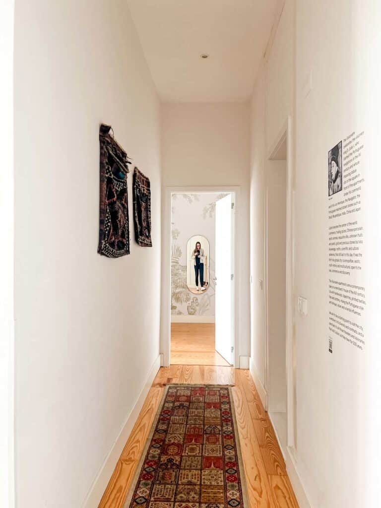 Hallway way with rug, art on walls