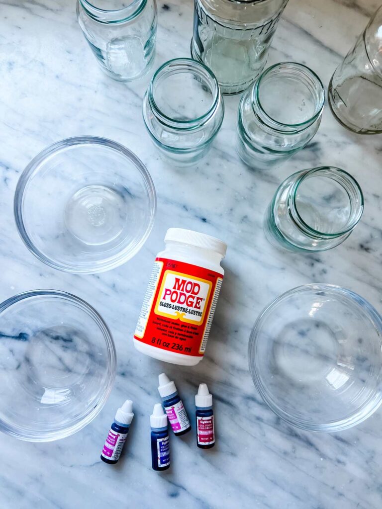 Supplies for how to make candy-colored glass jars for Valentine's Day.