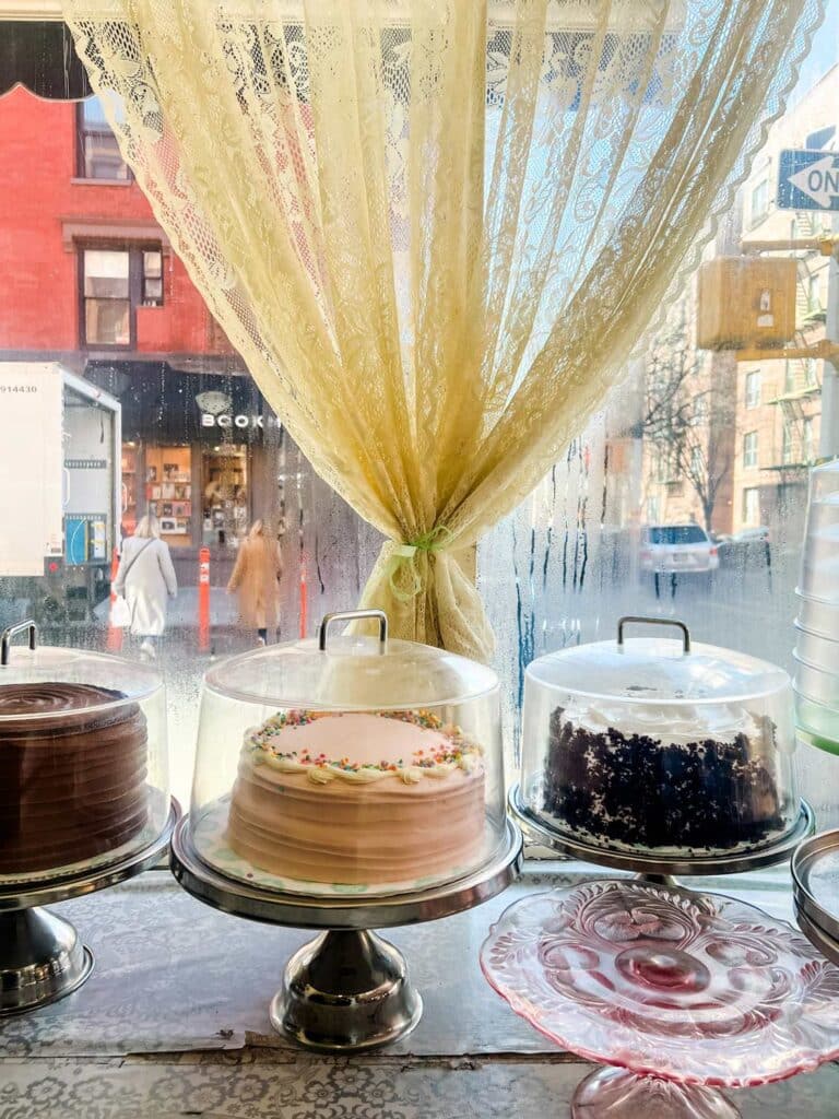 Decorated cakes sit in the window at Magnolia Bakery in New York City.