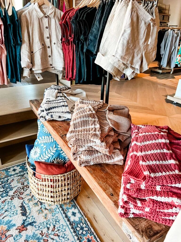 Striped cotton sweaters in color variations are displayed on natural wood shelves in the new Garnet Hill store at Legacy Place.