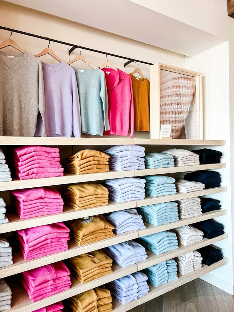 Shelves of washable cashmere sweaters in many different colors line the shelves in the new Garnet Hill store at Legacy Place.