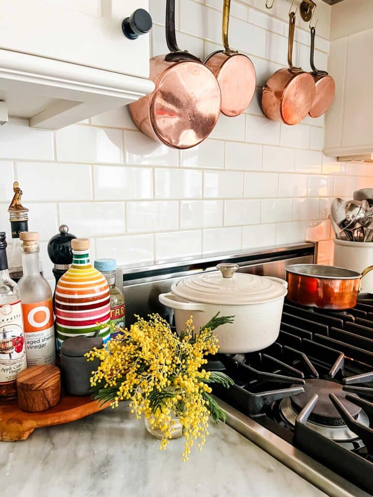 Simple ideas on how to refresh your home for spring include fresh flowers on your kitchen counters like these mimosas.