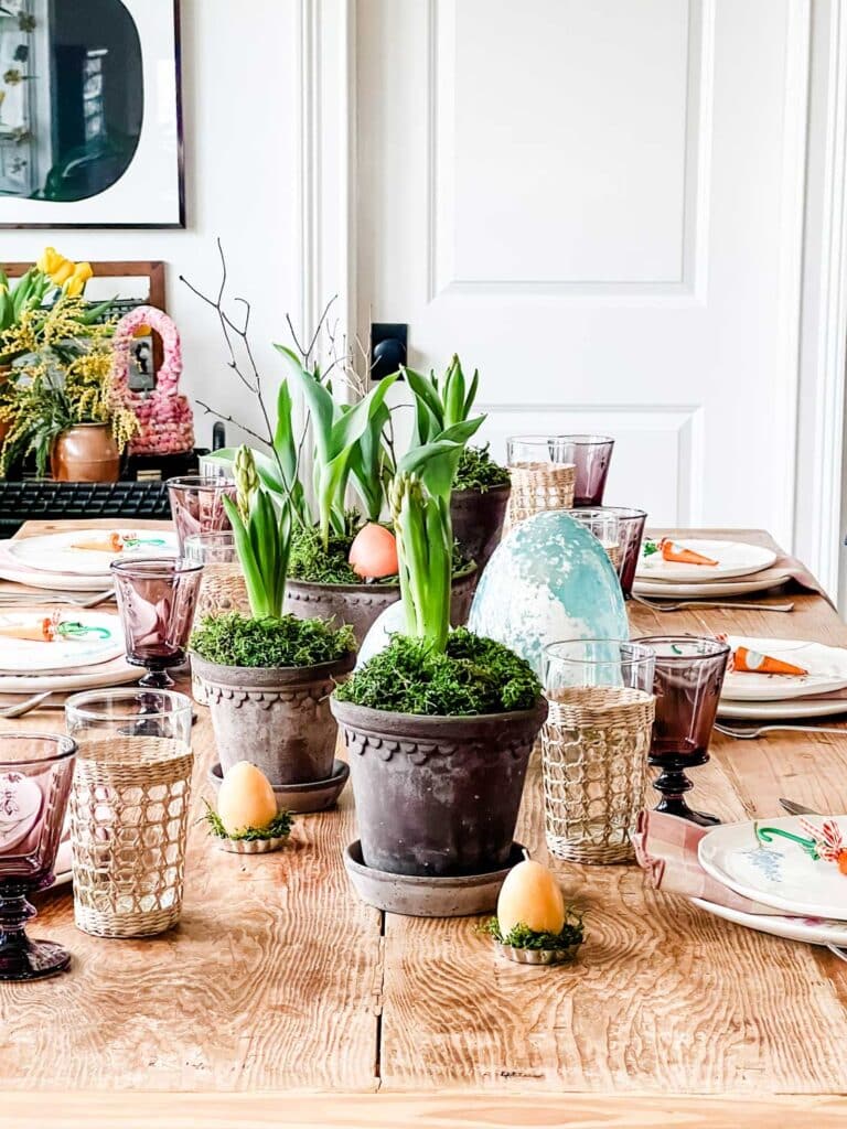floral plates, plaid napkins, glassware and Bergs pots filled with spring plants and moss