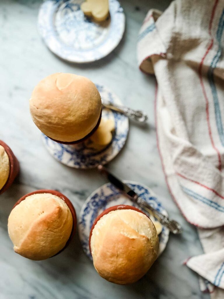 Clay flower pot bread with a red, white and blue striped vintage French tea towel.