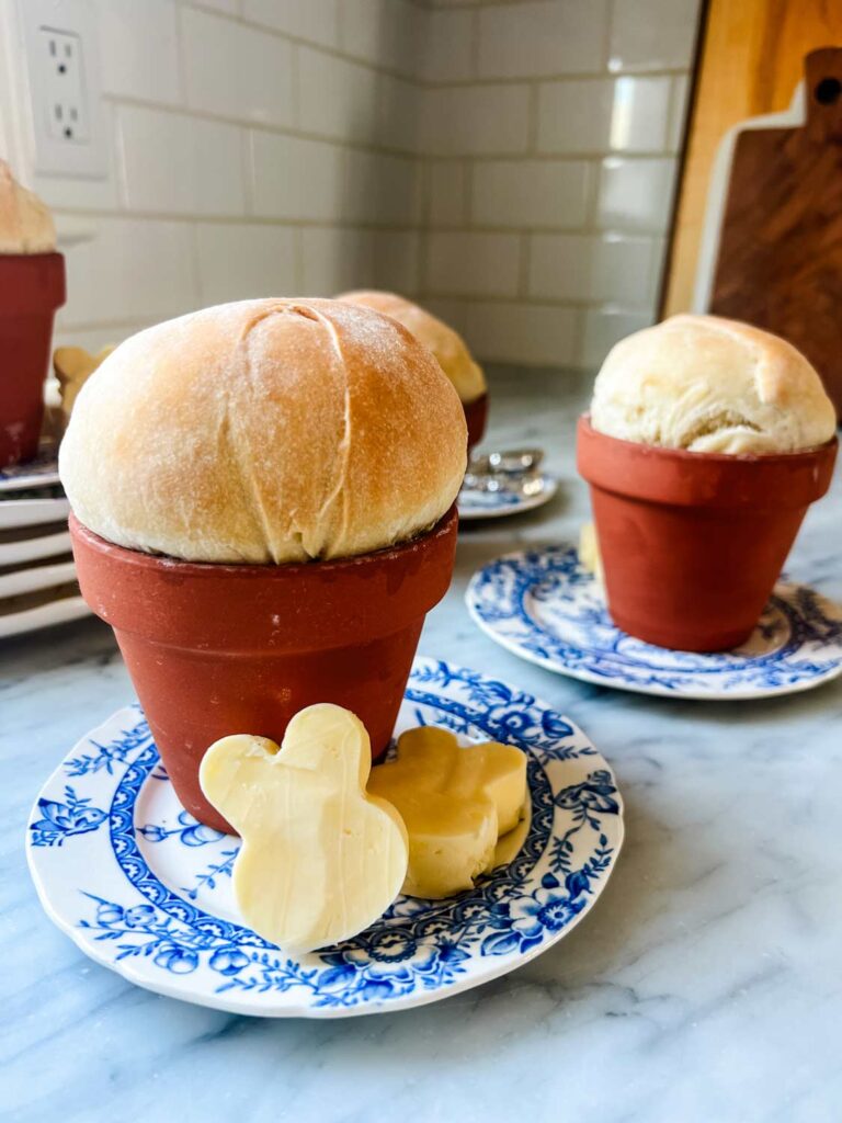 Bread baked and served in clay flower pots with butter formed in the shape of bunnies for Easter brunch.