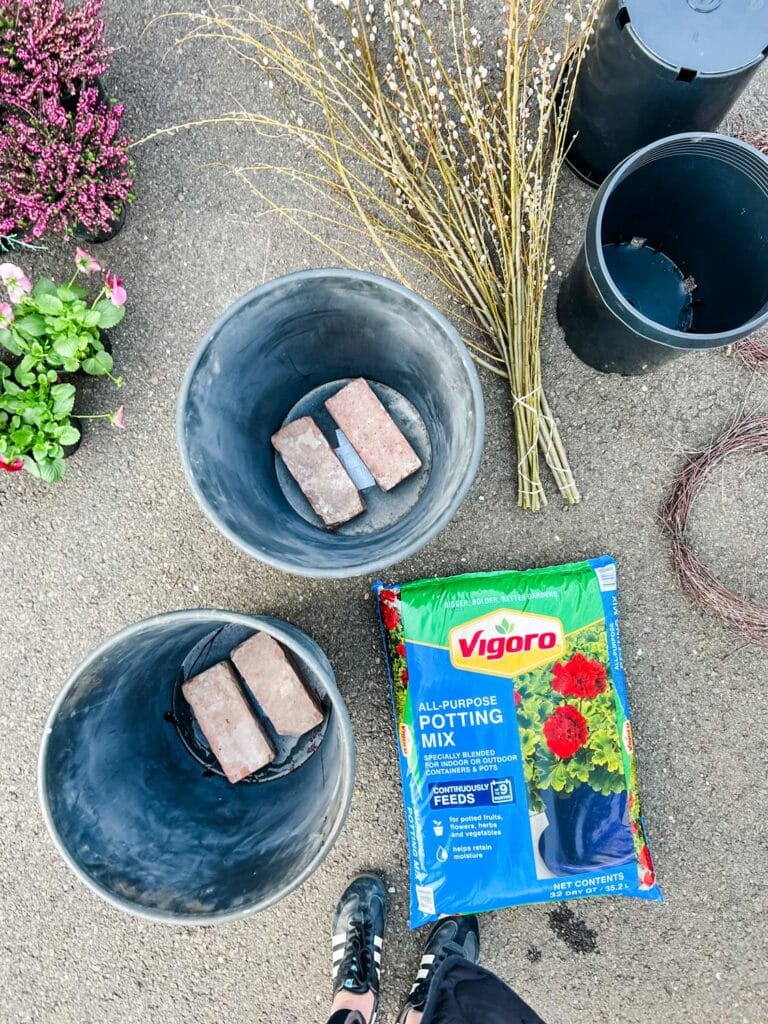 Potting soil, a few bricks, plastic liners, and spring flowers are all you need for your spring pots planter that won't leak water. 