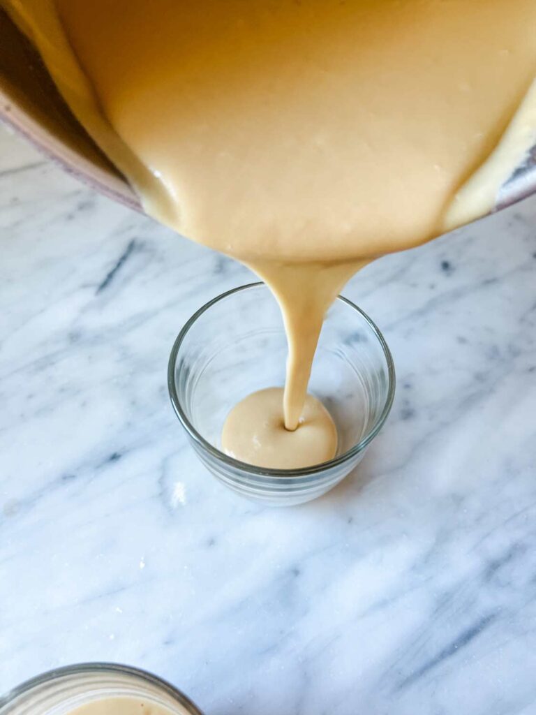 One step in how to make the best homemade butterscotch pudding is pouring it into serving glasses.