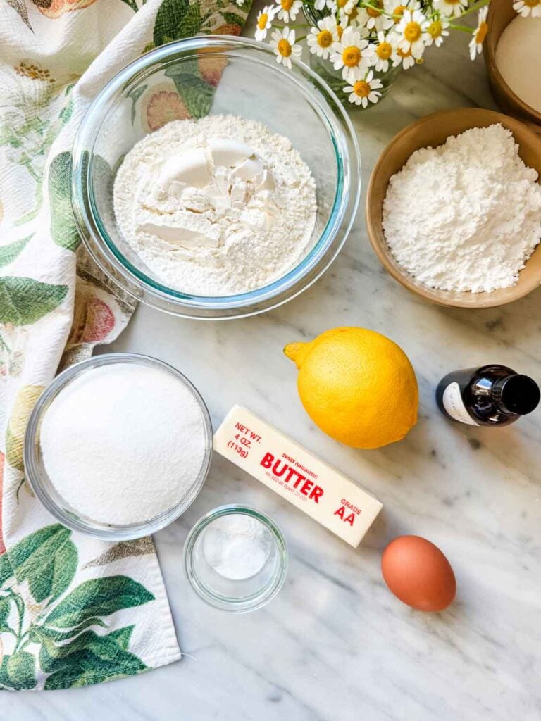 All the ingredients are measured, place in containers and are set on a kitchen countertop ready for making cookies.