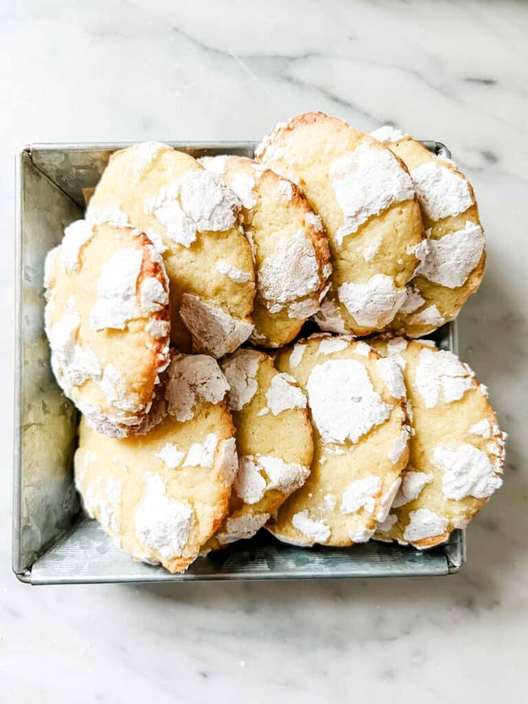 Powdered sugar coating on chewy lemon crinkle cookies is a must to get that crackly, crinkly look.