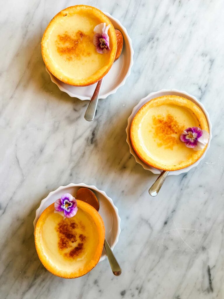 Hollowed-out orange peel cups are perfect for serving creamy orange posset with brûlée topping.