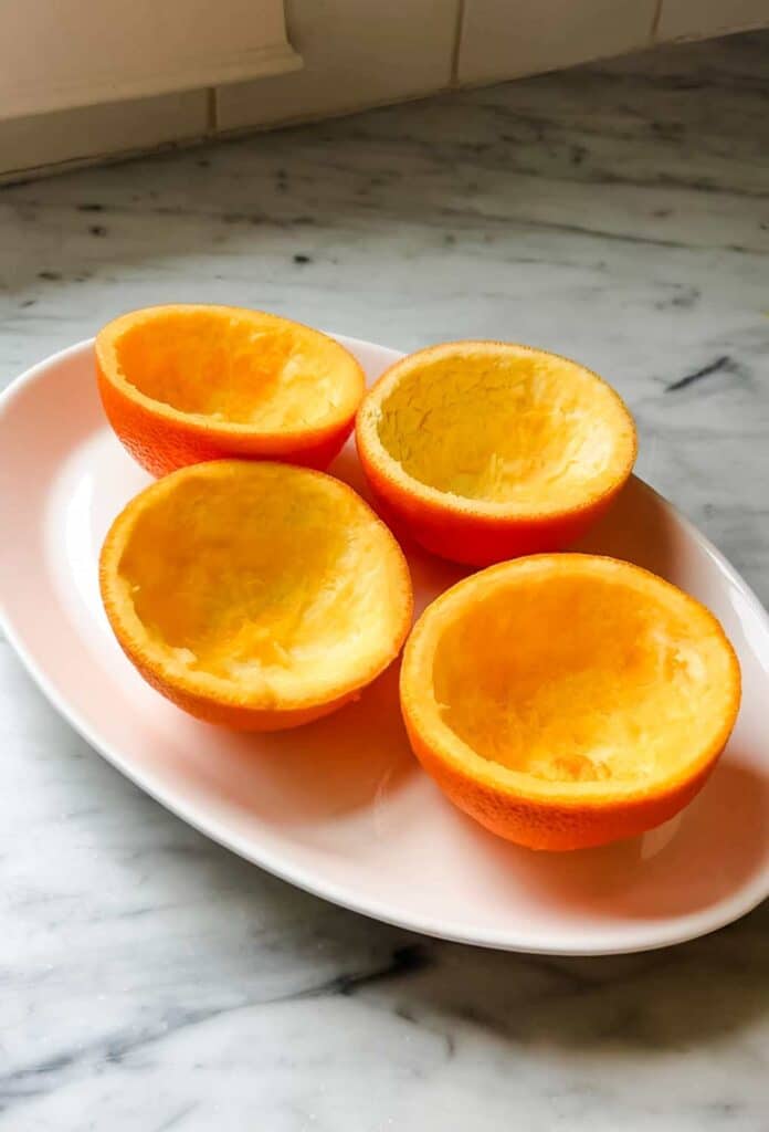 Hollowed-out orange peel cups are a great way to server the crowd-please citrus dessert called orange posset.