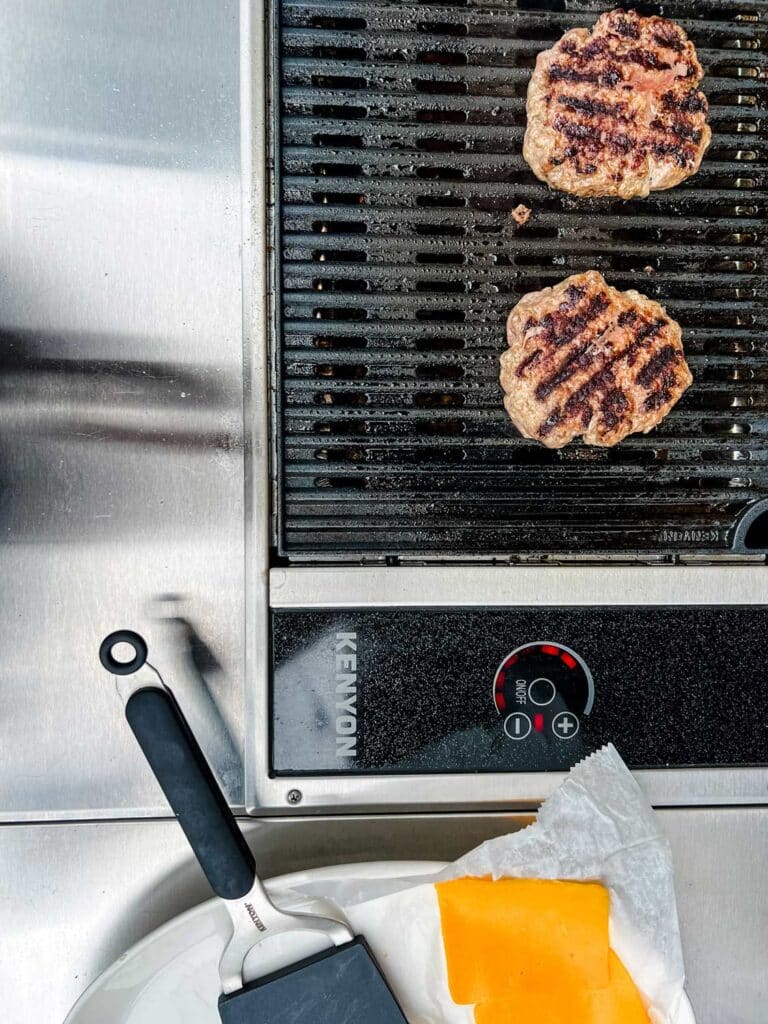 Burgers cooking on a Kenyon electric grill.