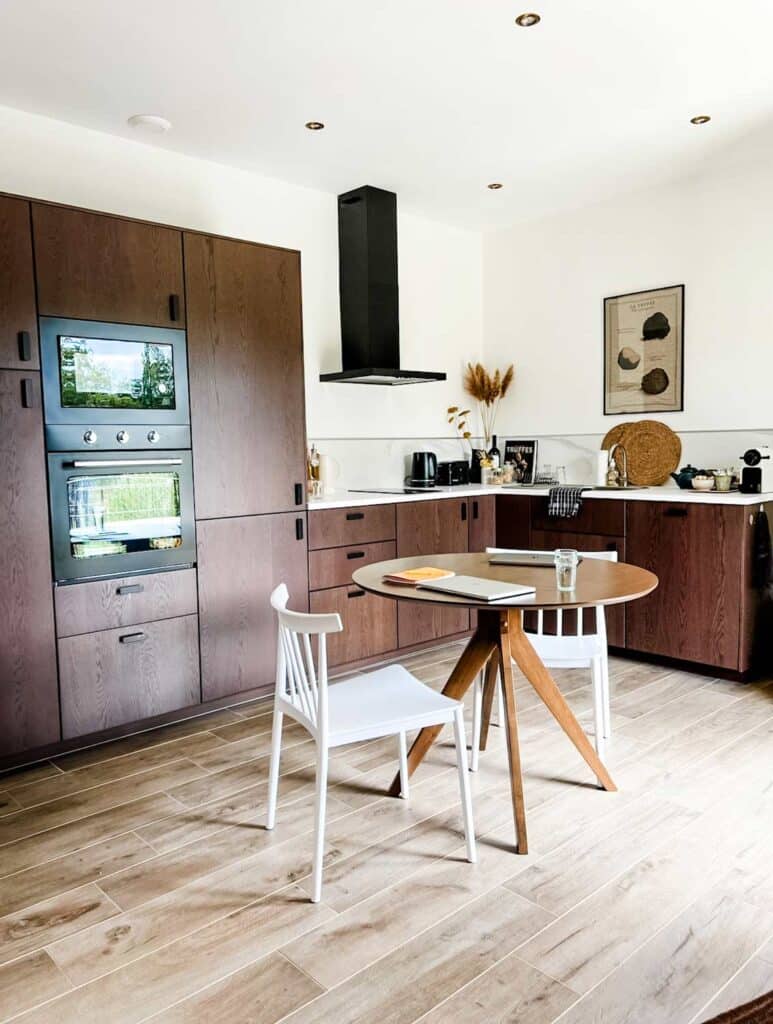 A fully equipped kitchen with a small eating table are featured in the Airbnb in Provence, France.