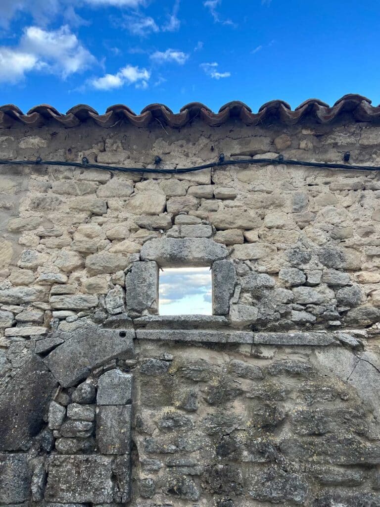 Carved out of an ancient stone wall is a small window in the old village of Lacoste, France.