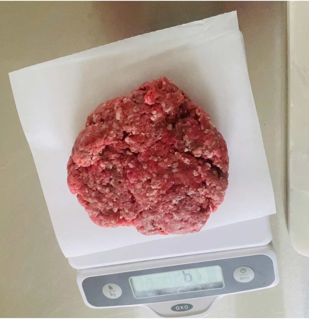 A white scale with paper on top is ideal for making all your hamburger patties the same size.