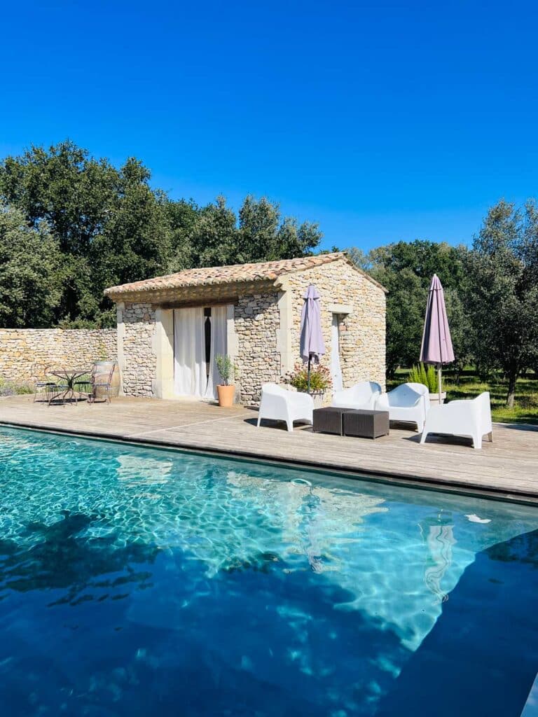 A pool house is next to a beautiful swimming pool on an estate in the south of France.