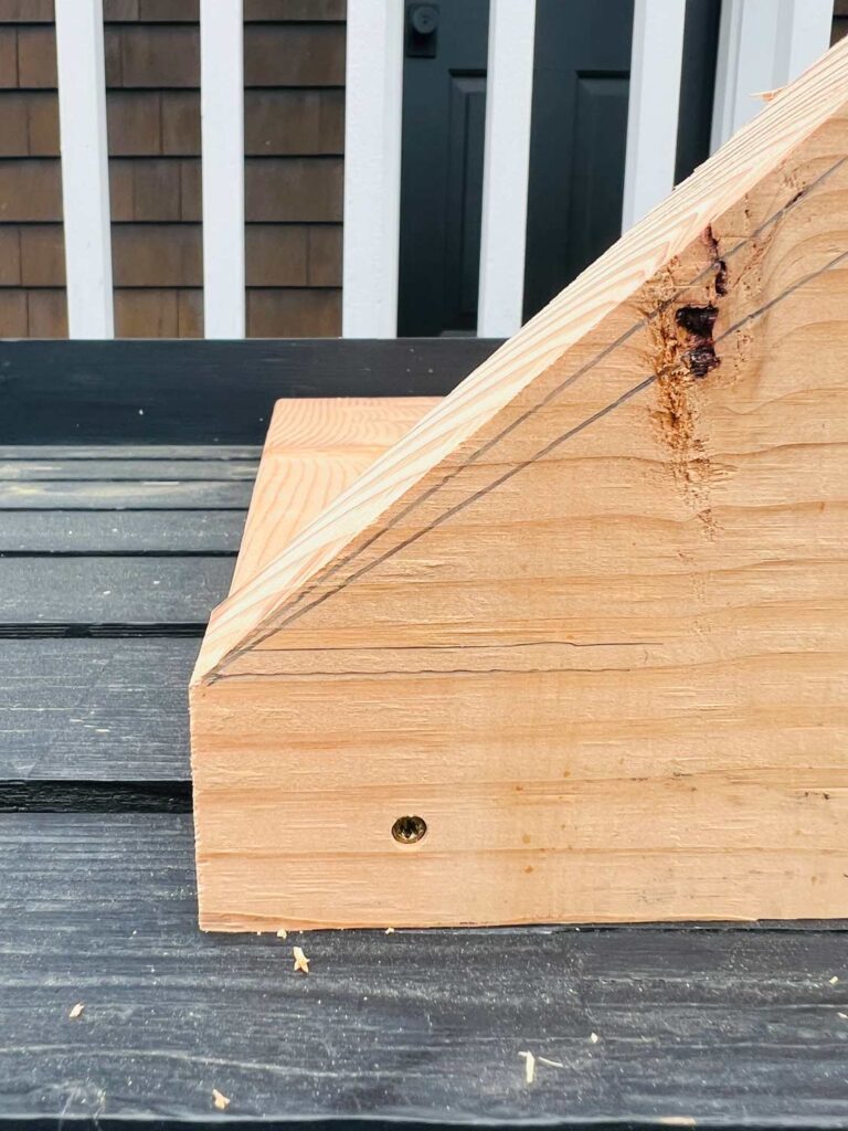 Side and bottom pieces of a wood potting tray have been attached with self-setting screws.
