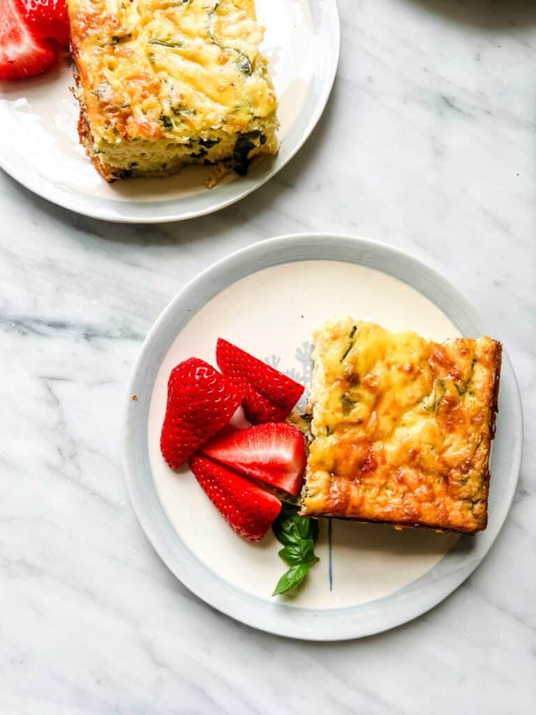 basil frittata on plates with strawberries