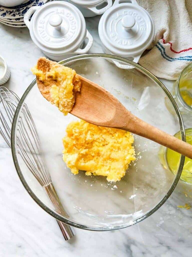 Sugar, butter, and egg yolks have mixed and are ready for the flour.