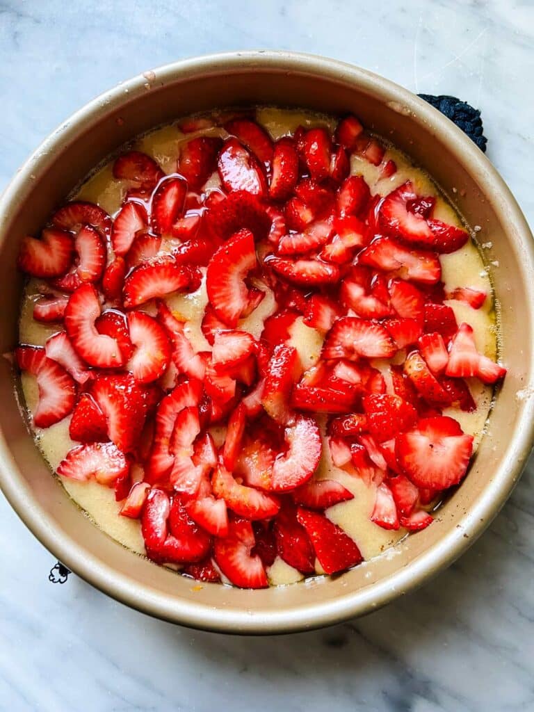 Fresh strawberries are spread in an even layer on top of the cake batter to make a surprisingly simple summer strawberry spoon cake.
