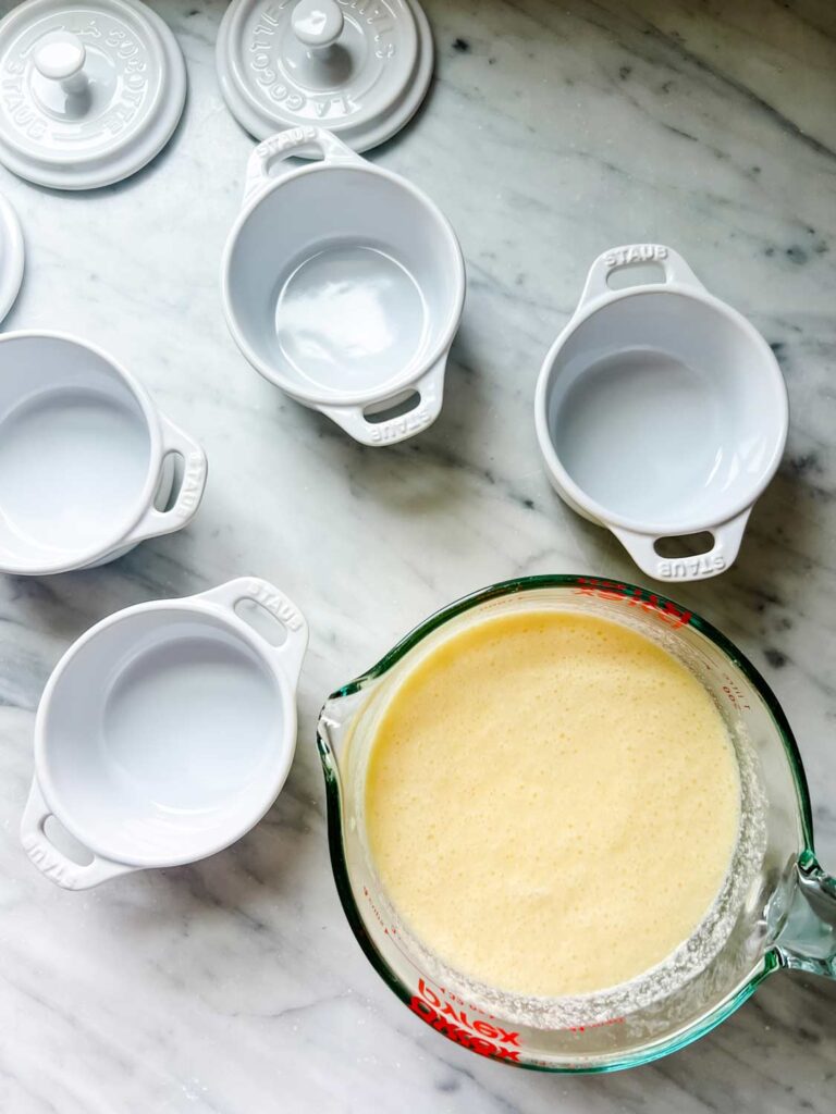 The lemon pudding mixture is ready to be poured into mini Staub cocottes and then into the oven for baking.