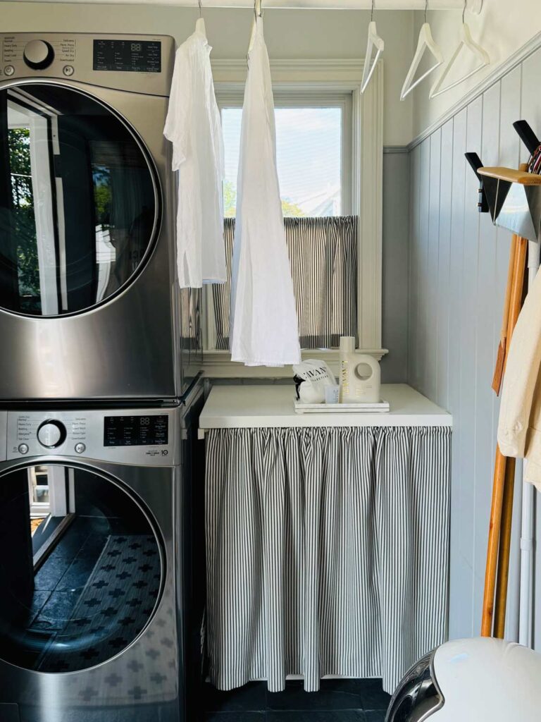 small laundry room, with skirted cabinet, window above.