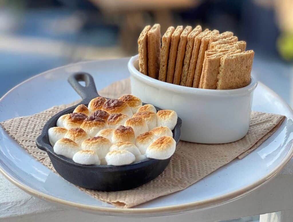 Skillet s'mores are served with graham crackers for a fun summertime dessert.