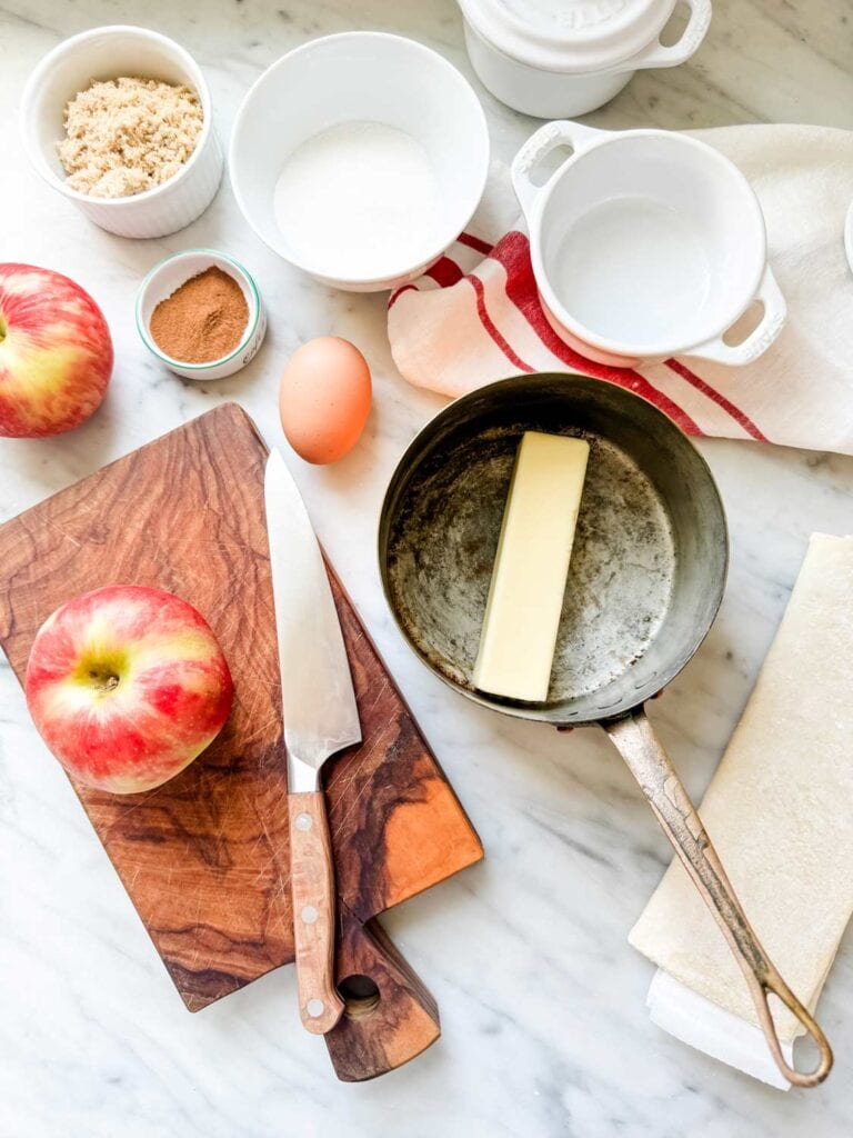 All the ingredients for puff pastry apple roses and sitting on a kitchen counter and ready to be assembled.