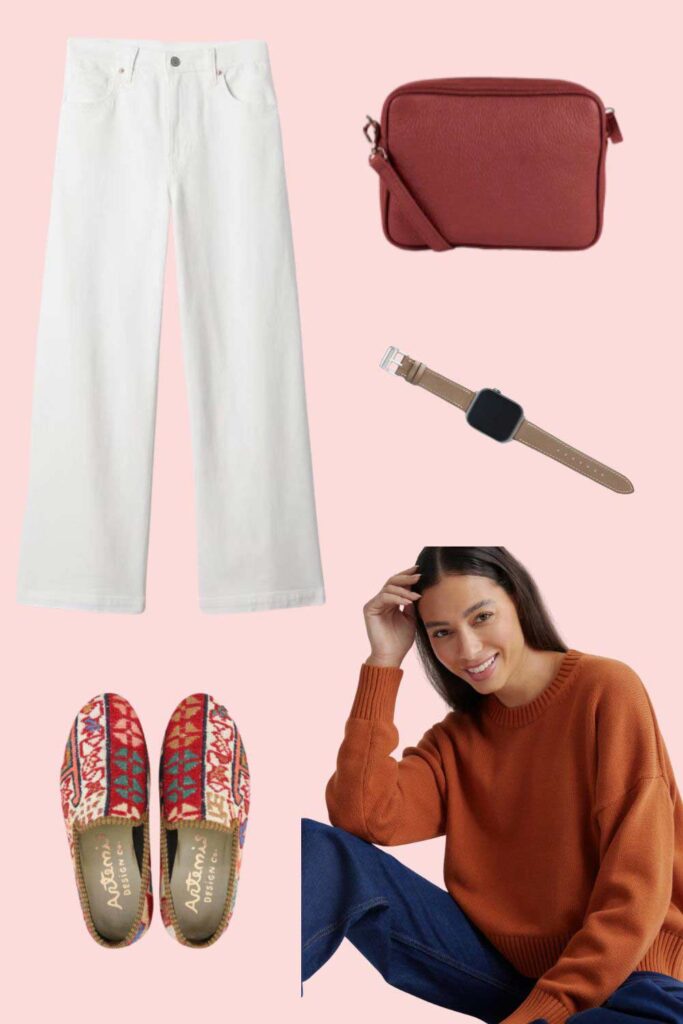 graphic with white jeans, shoes, red bag, woman wearing rust colored sweater.