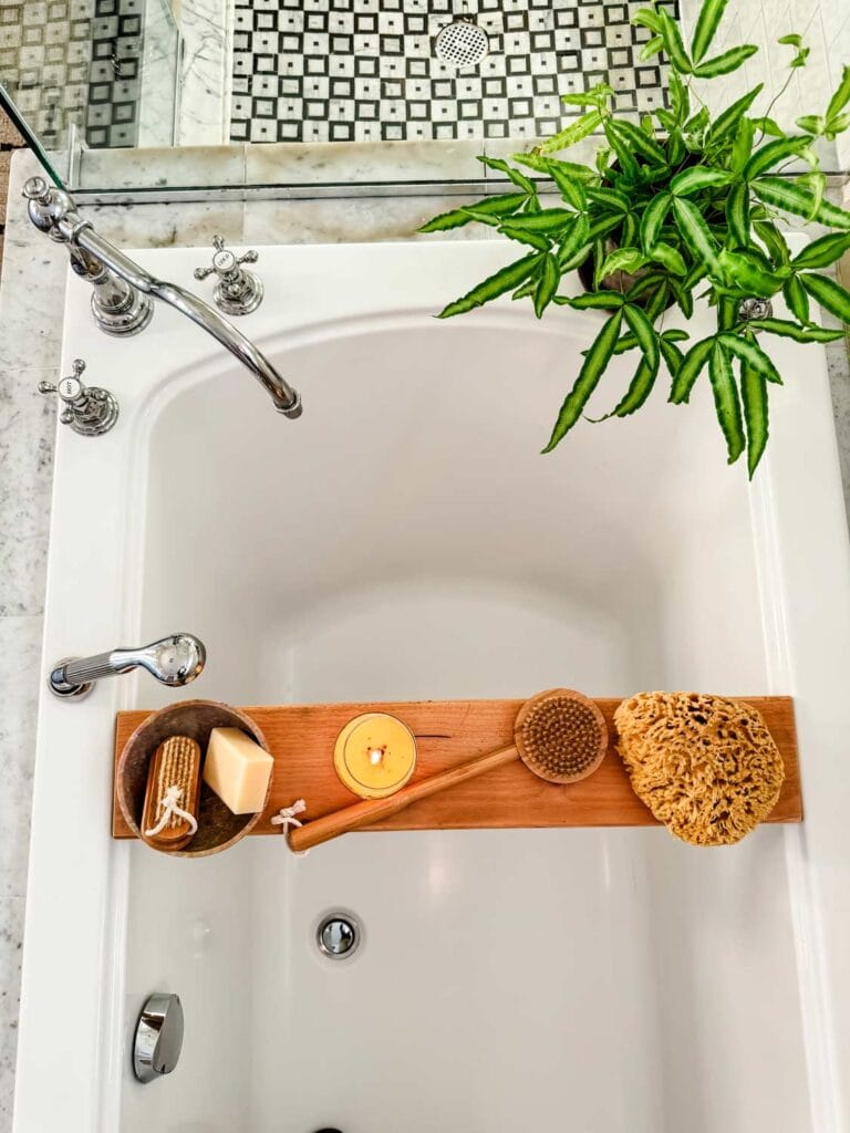 Primary bathroom refresh: small ideas to inspire you: Plant on edge of tub woth chrome fixtures. 