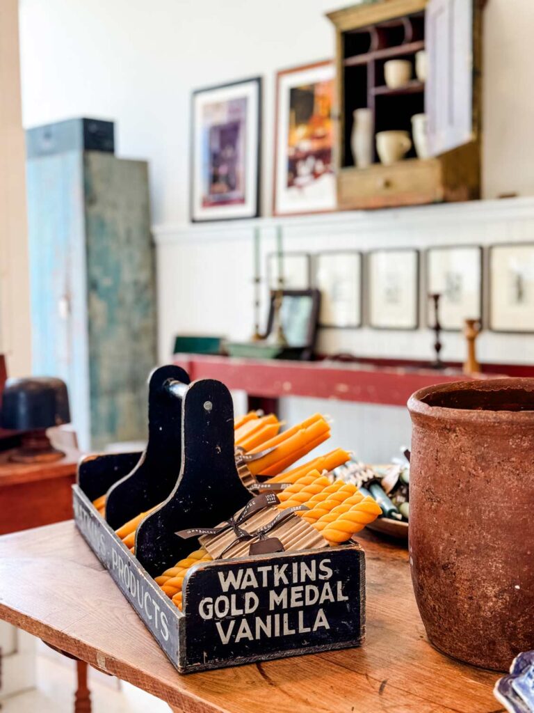 black vintage crate holding beeswax candles