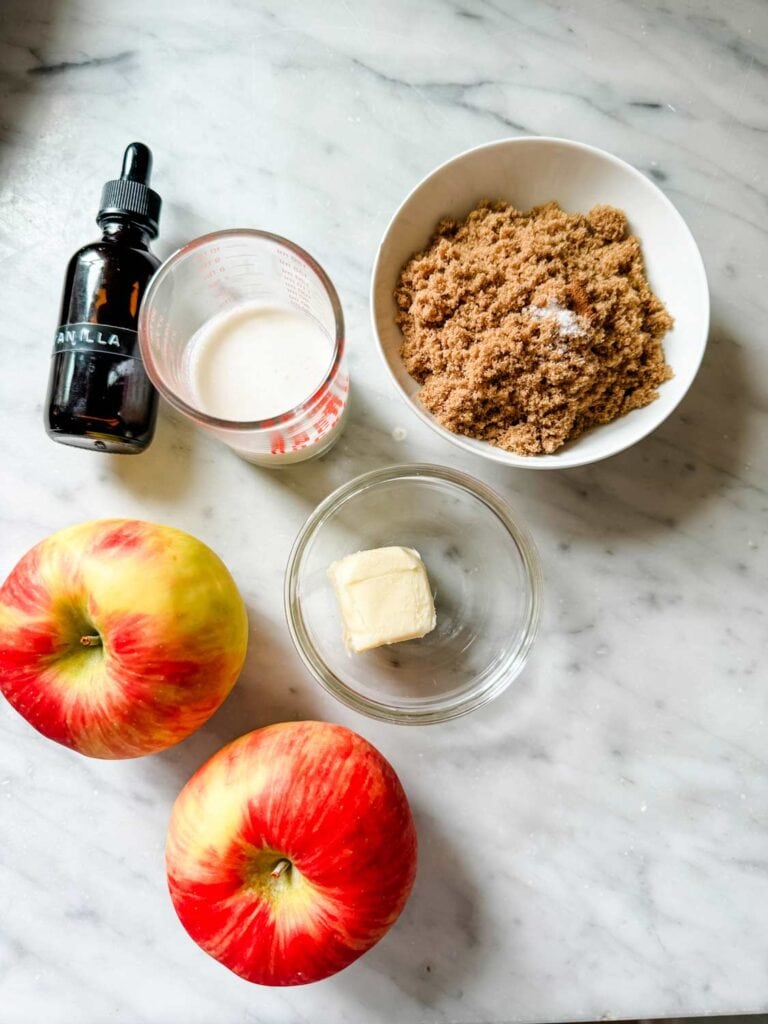 Brown sugar, whole milk, vanilla extract, butter and honey crisp apples are on the kitchen counter and ready to make caramelized apples for a Dutch Baby pancake.