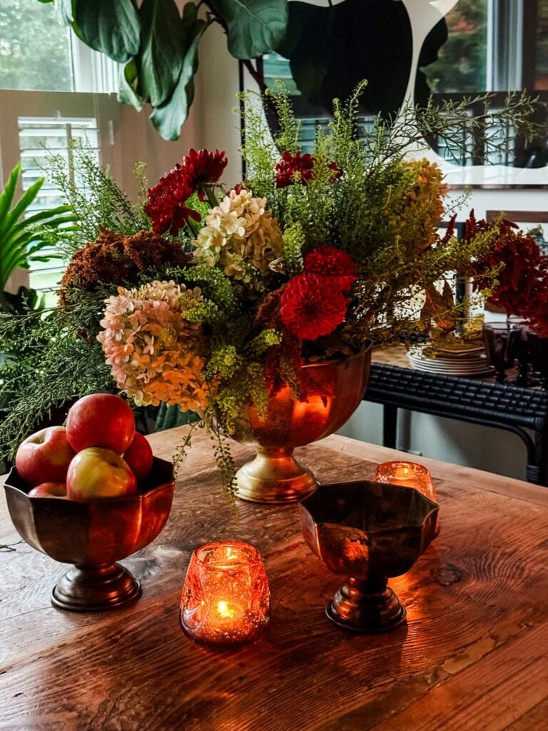 Make a Fall Centerpiece with Trader Joe's Flowers amd apples, votive candles.