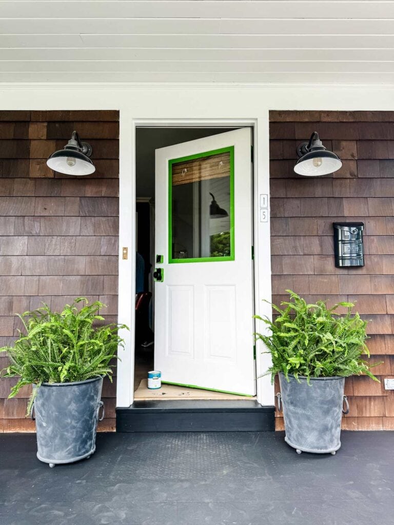 The front door of a Nantucket-style has been prepped and taped and is ready for painting.