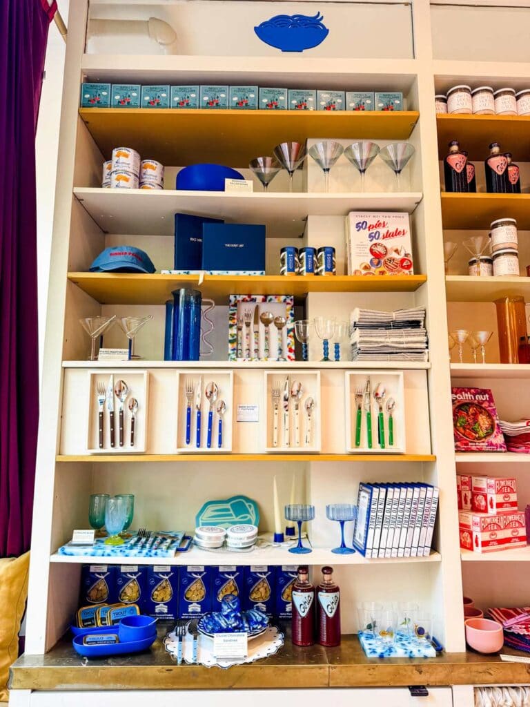 Store shelves at Big Night in the West Village of NYC are stocked with silverware, glasses, books and even some food.