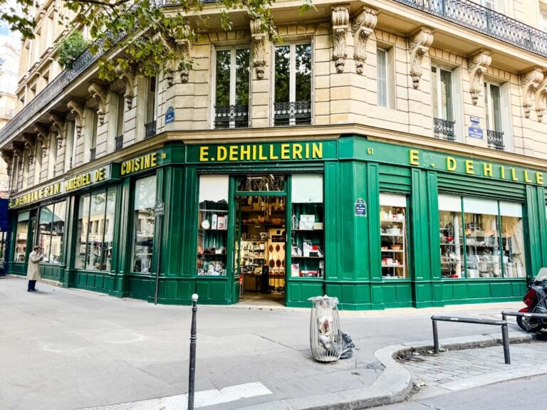 Seen from the street is the cooking supply store E. Dehillerin. The facade is green with yellow signage.