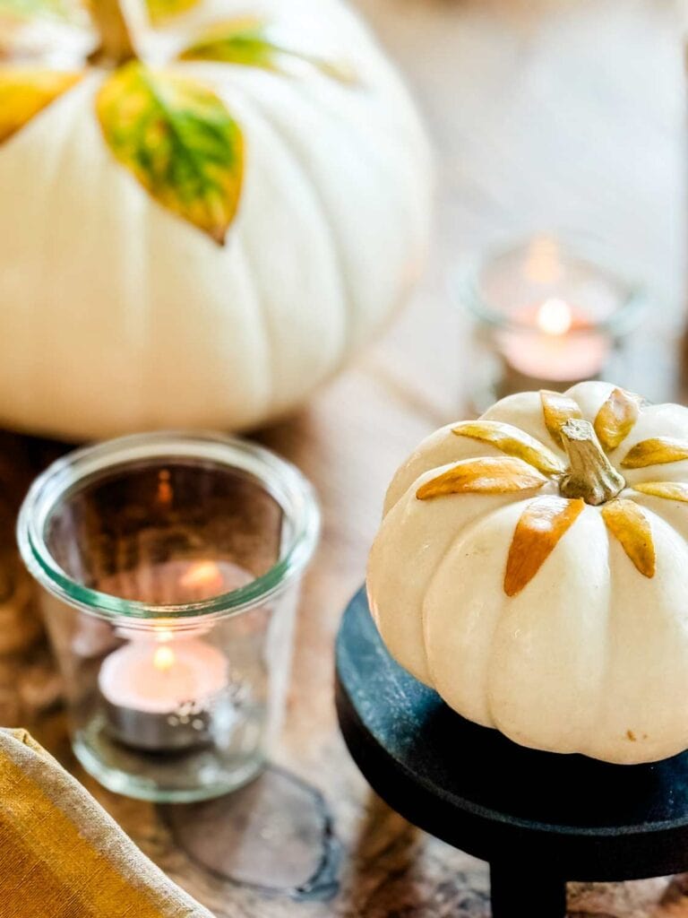 White pumpkins with decoupaged leaves, tea light in glass jar.