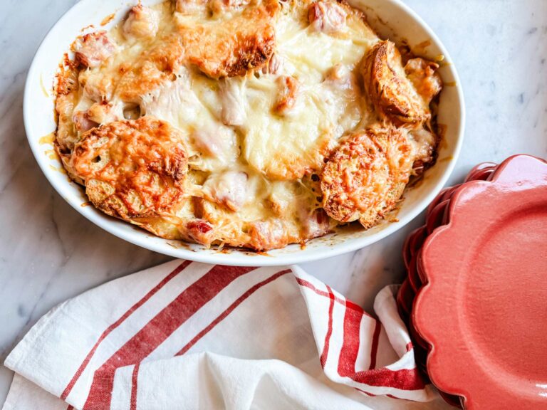 Croque Monsieur breakfast casserole is baking in an oval Apilco baking dish.