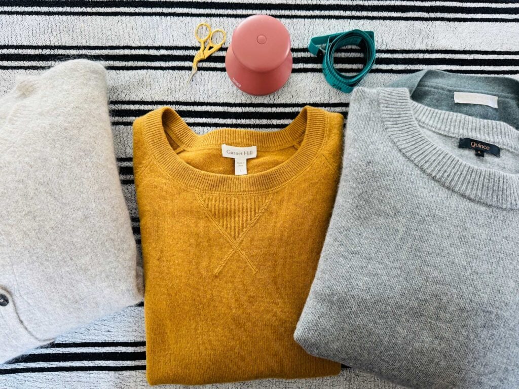 Cashmere sweaters on stripe towel.