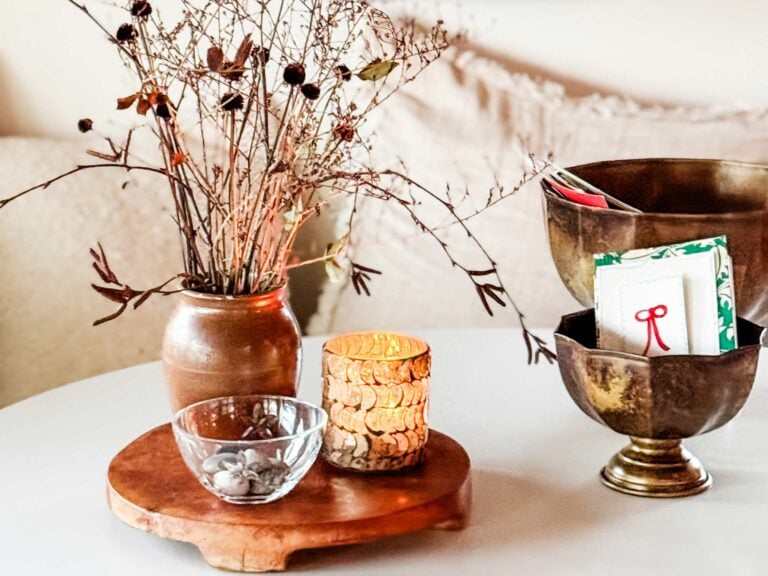 Forraged winter sticks and seeped in a vase next to a candle.