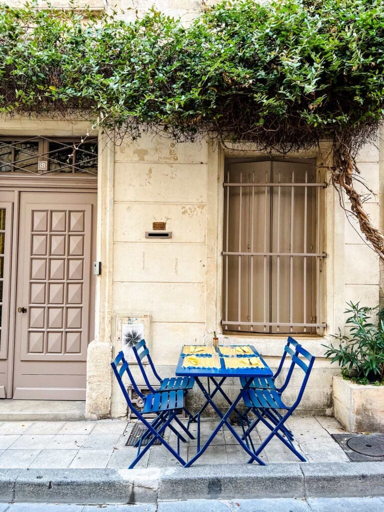 French blue tables and chairs on a sidestreet in Arles, France.