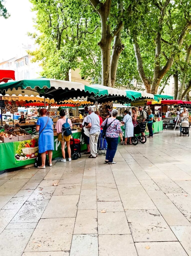 Shoppers are buying daily provisions during market day at Aix en Provence.