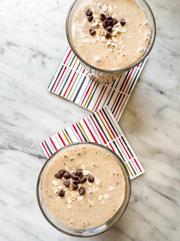 Two healthy date protein shakes are served on colorful napkins.