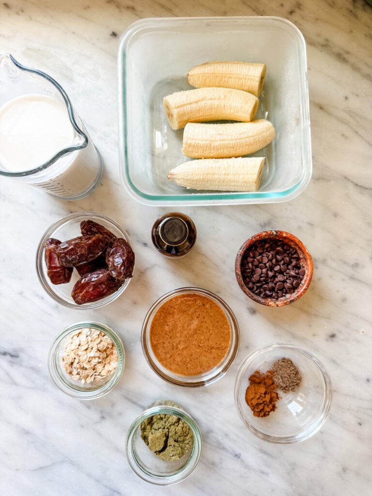 All the ingredients for a healthy date protein shake are measured and placed in small containers.