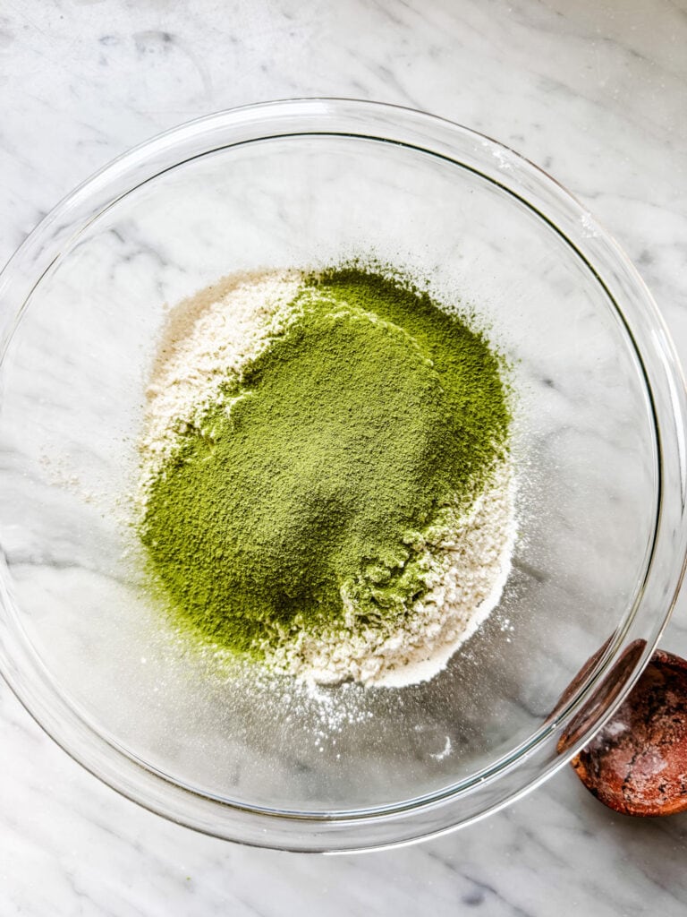 Sifted match powder over flower in a medium glass mixing bowl.