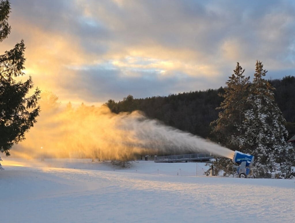 Snowmaking machines at work as the sun goes down at Mohawk Mountain ski resort.