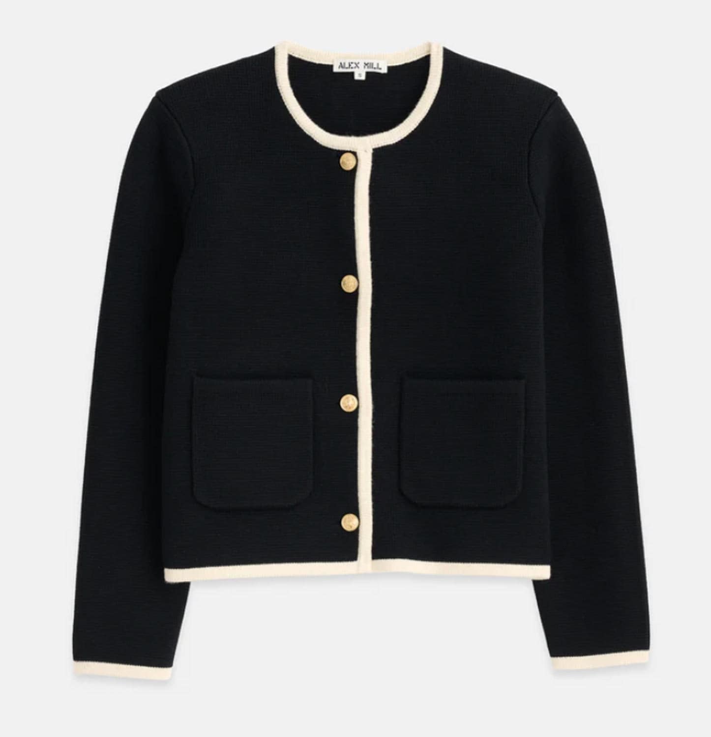 Black sweater with cream trim, gold buttons.